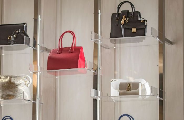 beautiful purses on a clear rack