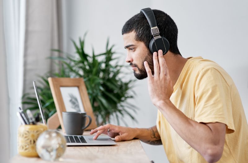 man working at home using a noise cancelling headphone
