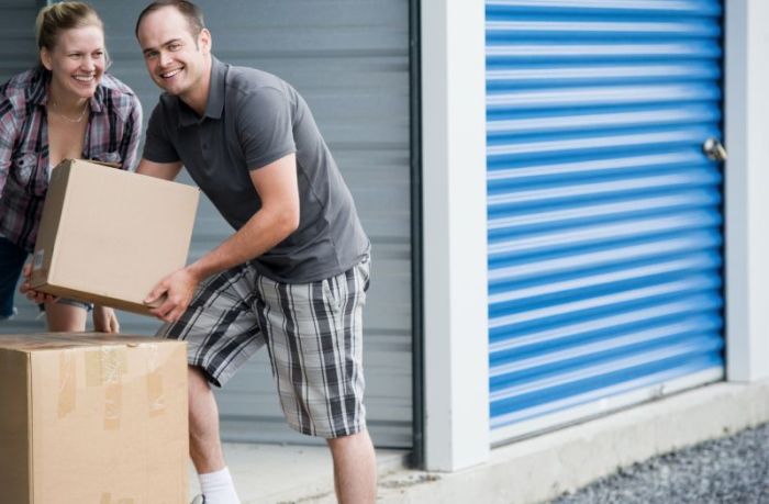 couple moving their boxes in the storage unit